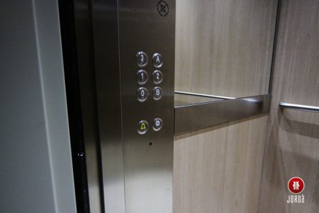 Botonera de inoxidable en forma de columna en el interior de una cabina de ascensor