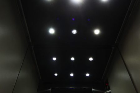 Interior de una cabina de ascensor con techo de iluminacion led